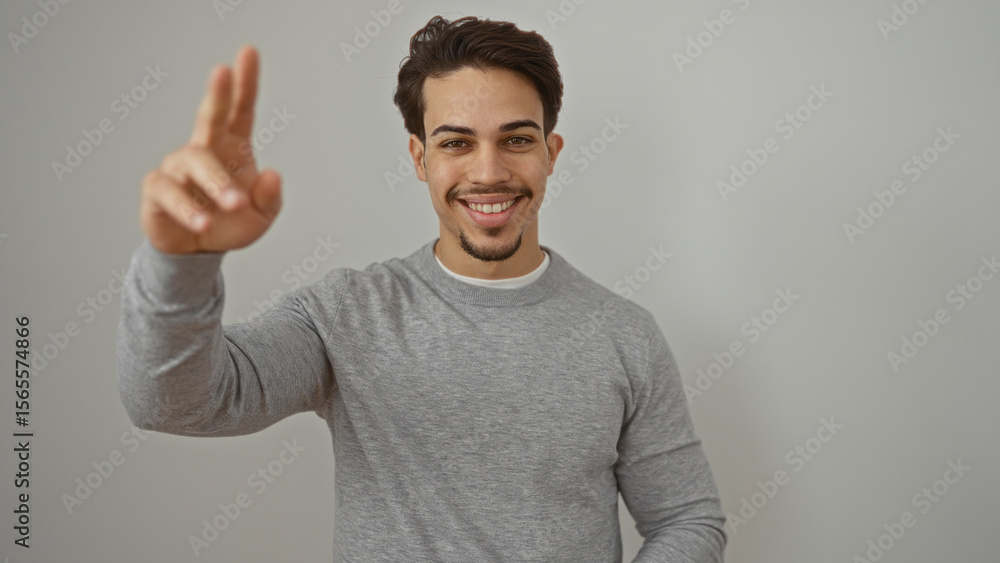 Fototapeta premium Handsome young hispanic man smiling isolated over white wall with casual style and expression