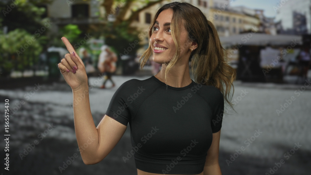 Fototapeta premium Woman pointing finger to side in plaza; friendly greeting.