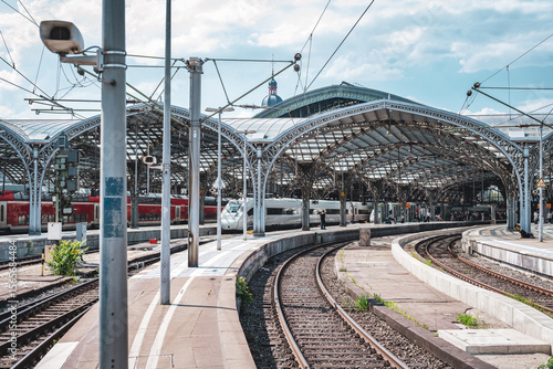 Train at a city railway station in Cologne with tracks and urban surroundings