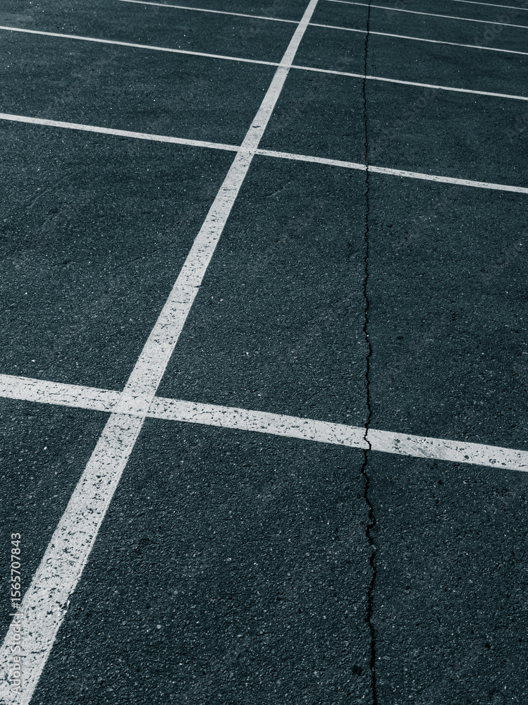 Fototapeta premium Cracked Asphalt Surface With Parking Grid Lines 