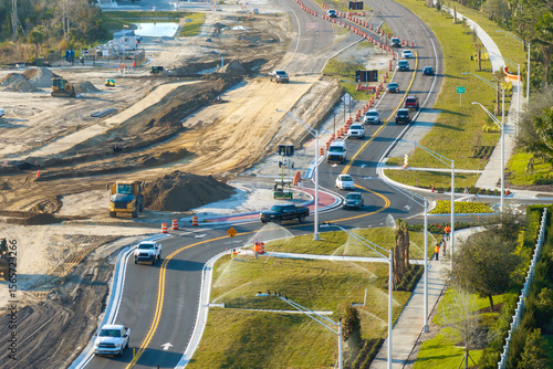 Quadro su tela Driving traffic cars at roundabout intersection under construction