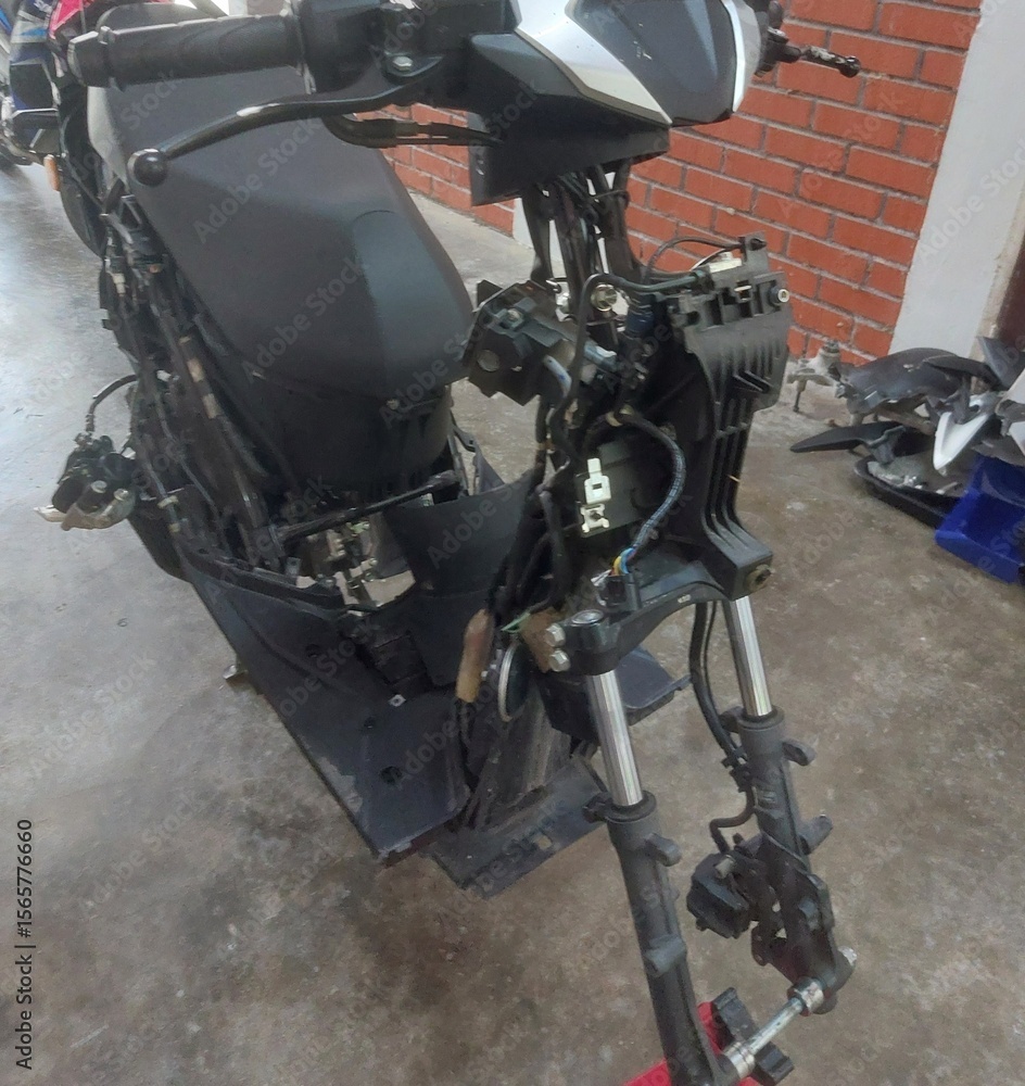 Obraz premium Disassembled motorbike frame and rim spraying in workshop