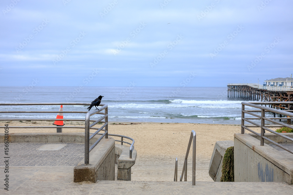 Access path guarded by metal barriers to shores of Pacific beach near public wooden Crystal pier in San Diego, California Access path guarded by metal barriers to shores of Pacific beach near public wooden Crystal pier in San Diego, California