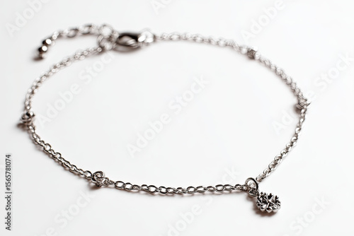 Wallpaper Mural Delicate silver bracelet with intricate charm displayed on a soft white background, ideal for jewelry promotion Torontodigital.ca
