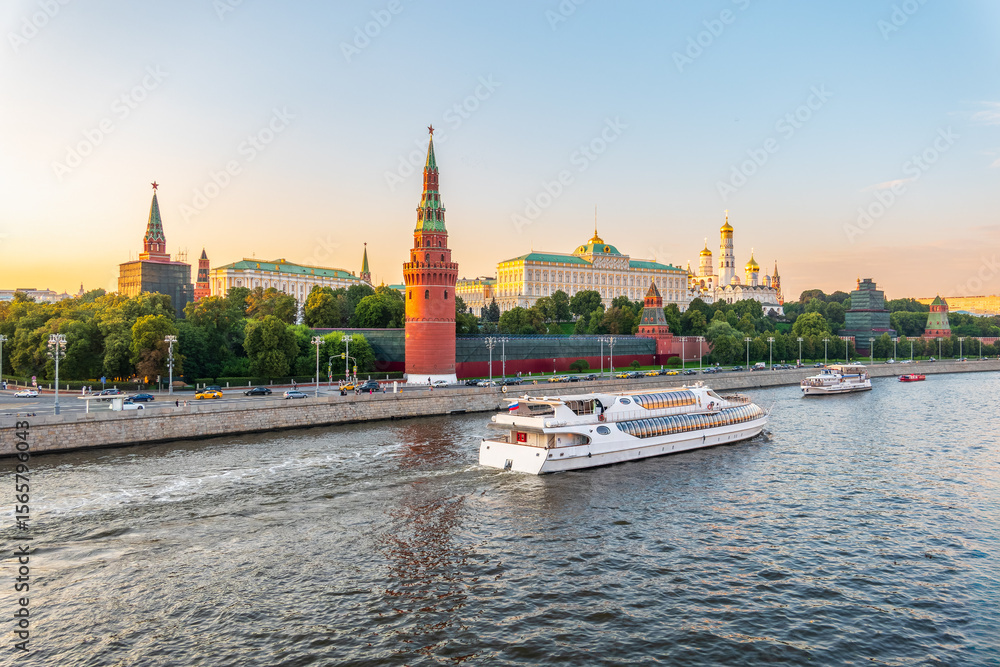 View of Kremlin with Vodovzvodnaya tower, Grand Kremlin Palace from repaired Bolshoy Kamenny Bridge in Moscow city on sunny summer day. Cruise ship sails on the Moscow river View of Kremlin with Vodovzvodnaya tower, Grand Kremlin Palace from repaired Bolshoy Kamenny Bridge in Moscow city on sunny summer day. Cruise ship sails on the Moscow river