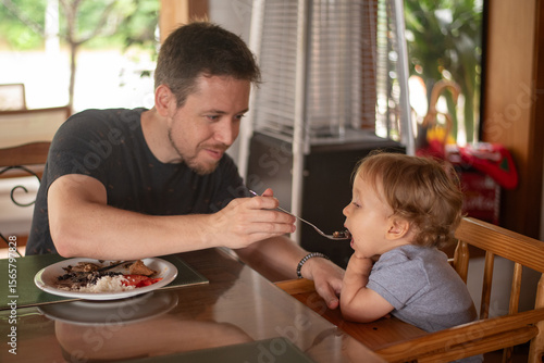 Father feeding his baby son