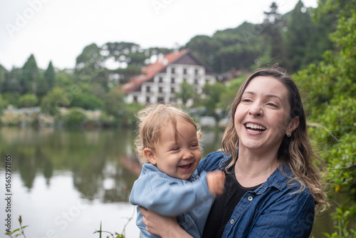 Mother holding her son, both laughing together at Lago Negro - Gramado - Rio Grande do Sul - Brazil