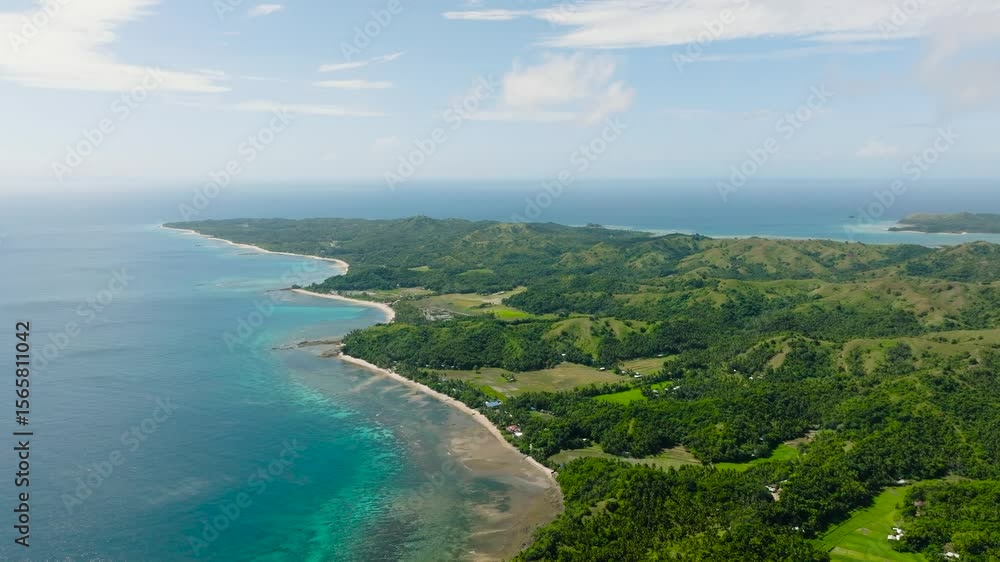 A scenic coastal view of turquoise ocean waters bordered by green hills and peaceful shores. Santa Fe, Tablas, Romblon, Philippines. A scenic coastal view of turquoise ocean waters bordered by green hills and peaceful shores. Santa Fe, Tablas, Romblon, Philippines.