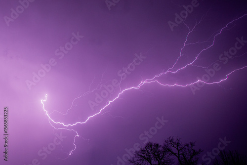 Purple Night Sky Illuminated by Forked Lightning