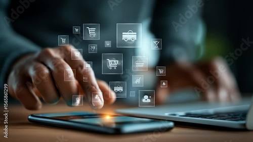 Wallpaper Mural Person Interacting with Digital Shopping Icons on Smartphone with Laptop Featuring Dark Clothing and Warm Lighting for E-Commerce Concepts Torontodigital.ca