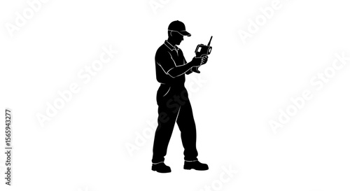 A silhouetted technician carefully examines a handheld device.