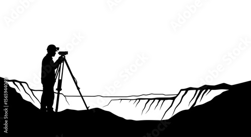 Silhouette of a surveyor using a theodolite on a cliff overlooking a canyon.
