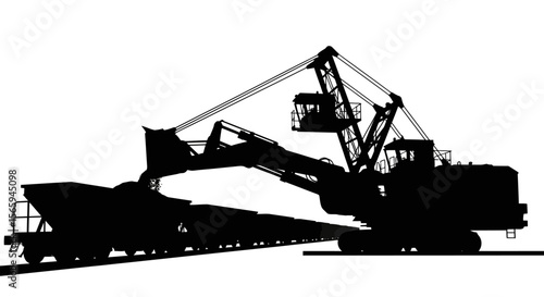 Large excavator loading a railcar with ore, industrial mining operation, heavy machinery silhouette.