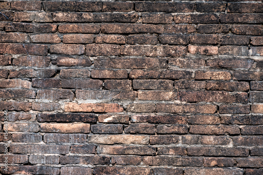 Full frame shot of an old brick wall textured and pattern. A brick is a type of block used to build walls. Full frame shot of an old brick wall textured and pattern. A brick is a type of block used to build walls.