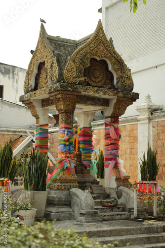 The spirit house stands outside as a sacred place to honor guardian spirits in Thai tradition.