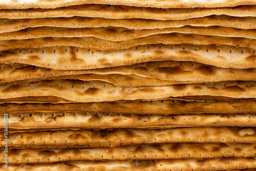 Close-Up View of Stacked Traditional Jewish Matzah Bread - Layered Texture of Unleavened Passover Crackers