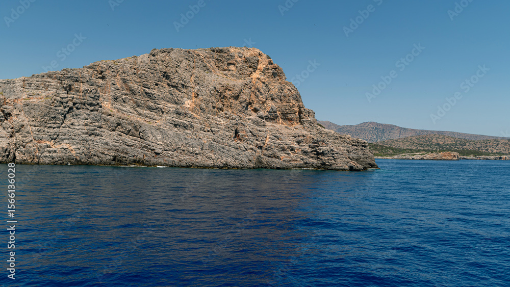 Fototapeta premium Stunning rocky coastline of Crete surrounded by vibrant blue waters