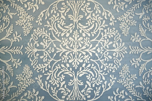 a light blue background with intricate white patterns