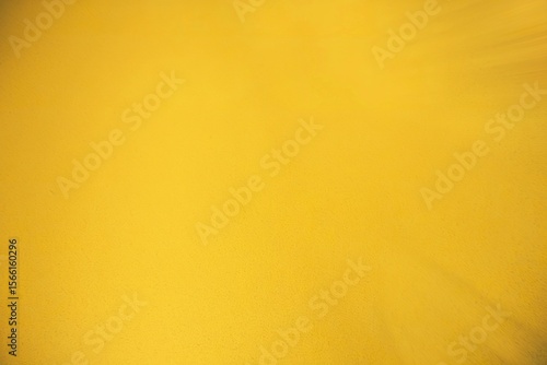 A photo of a vibrant yellow background