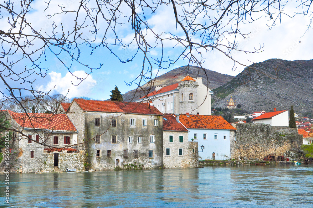 Obraz premium Historical buildings on the riverside in Trebinje, Bosnia and Herzegovina. Stone houses by the water. architectural ideas. 