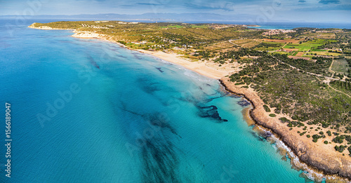 Fototapeta Naklejka Na Ścianę i Meble -  Aerial view of waves reaching a beautiful beach with turquoise water and golden sand on a sunny summer day