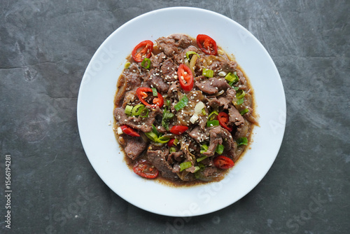 Bulgogi is a Korean food made from beef grilled with sauce and spices. on black background