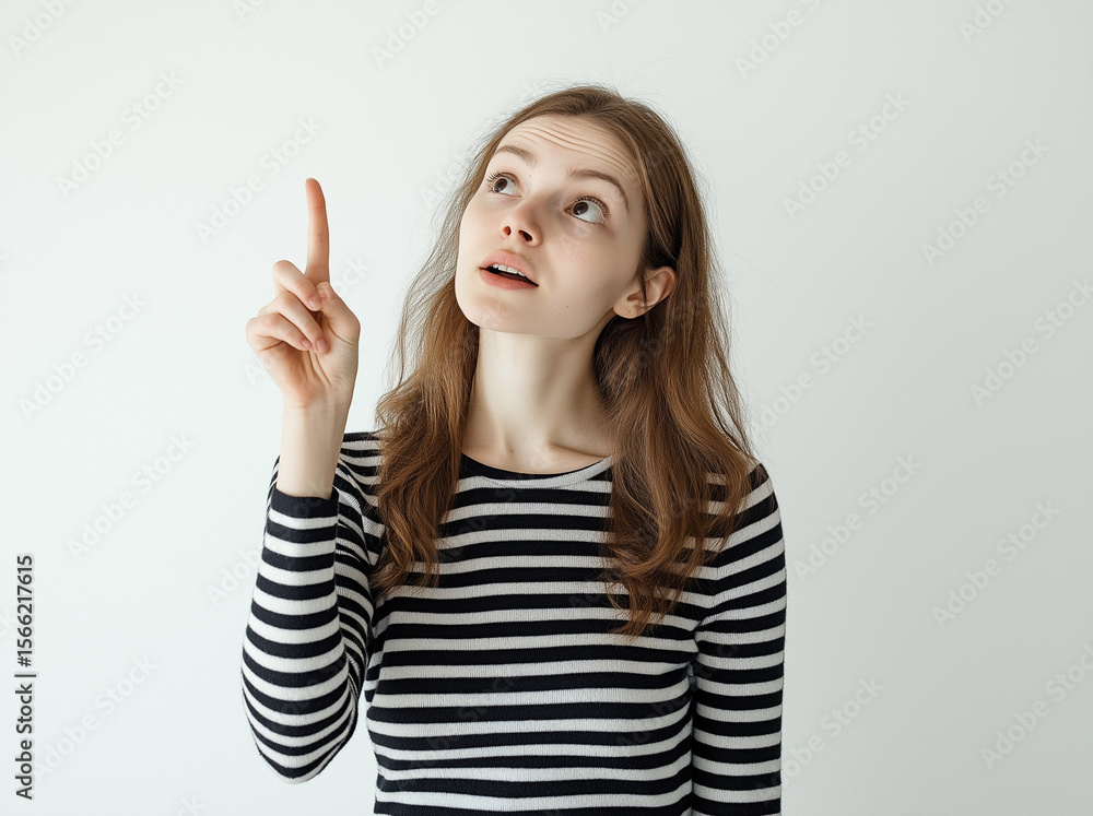 Full-Body Portrait of a Smiling Woman in Striped Top Pointing Up – Studio Shot with White Background, Perfect for Advertising, Branding, or Marketing Campaigns Full-Body Portrait of a Smiling Woman in Striped Top Pointing Up – Studio Shot with White Background, Perfect for Advertising, Branding, or Marketing Campaigns