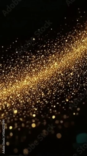 A stunning image showcases a shimmering trail of golden particles, reminiscent of glittering stardust or fairy dust, cascading across a deep black background, creating a magical and luxurious visual e