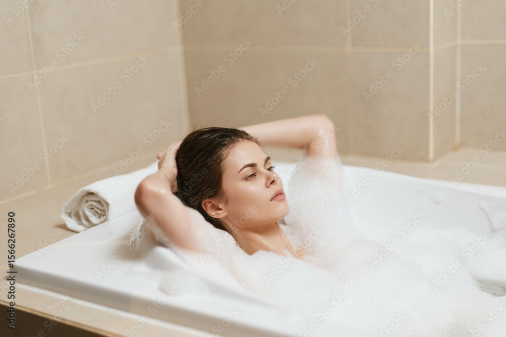 Relaxed woman enjoying a bubble bath, eyes closed and leaning back, surrounded by soft white foam in a serene bathroom setting. Spa and self-care concept. Relaxed woman enjoying a bubble bath, eyes closed and leaning back, surrounded by soft white foam in a serene bathroom setting. Spa and self-care concept.