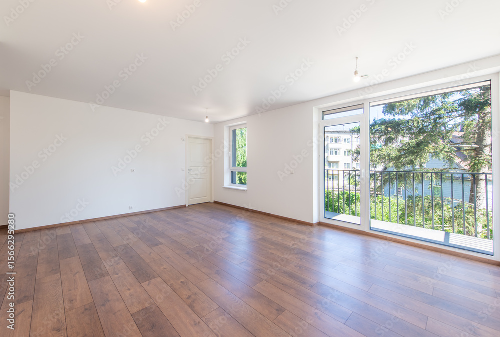Obraz premium Spacious Modern Living Room Interior with Hardwood Floors and White Walls