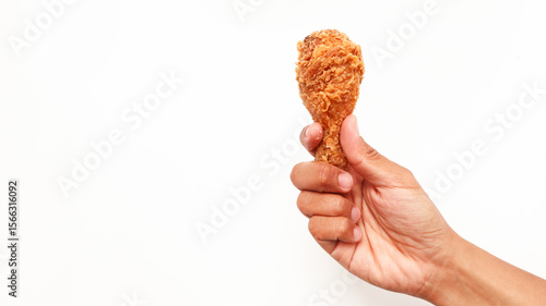 Hand hold fried chicken isolated on white background
