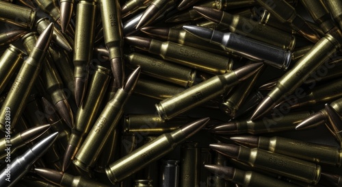 Dense pile of 5.56 caliber rifle ammunition cartridges and bullets