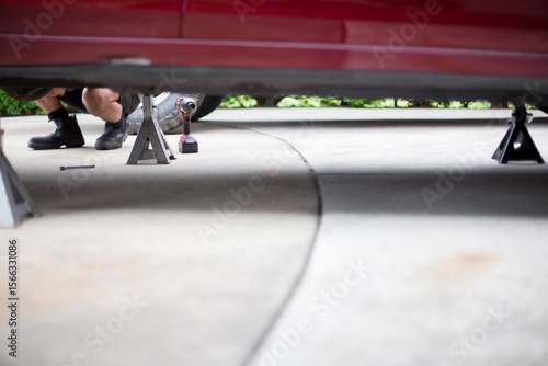 Wallpaper Mural A mechanic services a vehicle. Torontodigital.ca