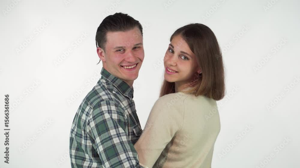 Joyful couple embracing and smiling at the camera, showcasing their love Joyful couple embracing and smiling at the camera, showcasing their love