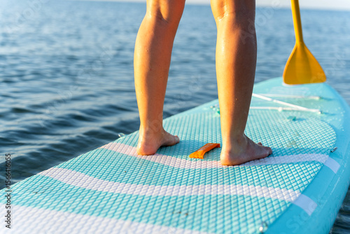 Photography Woman stand up paddle surfing in villajoyosa, spain, enjoying summer vacation