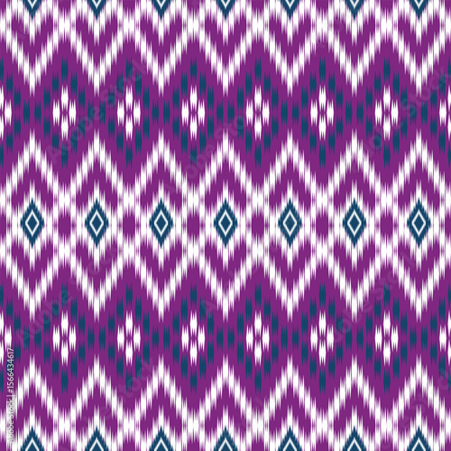 Seamless Ikat fabric pattern. The pattern looks dimensional and lively. Applications: Textiles, Fashion clothing, Tops, Skirts, Pants, Scarves, Bags, Curtains, Pillowcases, Sofa covers