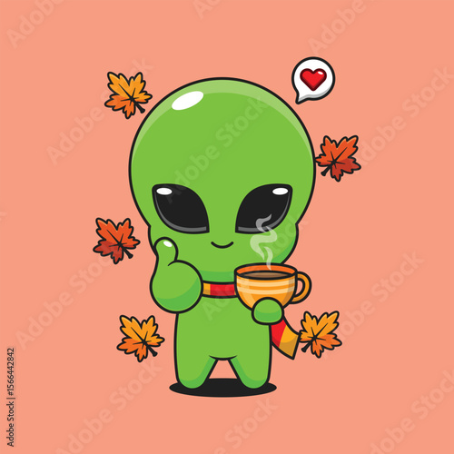 Cute alien holding holding a cup of coffee in autumn day cartoon vector illustration