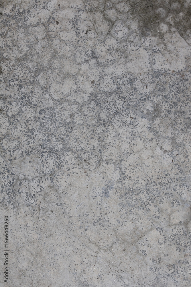 Obraz premium Close-up of a weathered gray concrete floor with cracks and texture