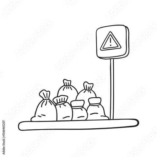 A street sign placed near cluttered bags on a city corner