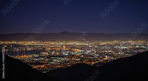 Breathtaking night cityscape view with distant mountains and starry sky
