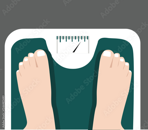 Top view of female feet standing on weighing scale