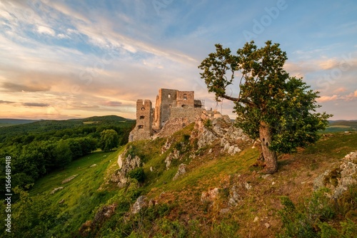 Cuadro en lienzo Medieval building illuminated by the setting sun and blue sky with clouds