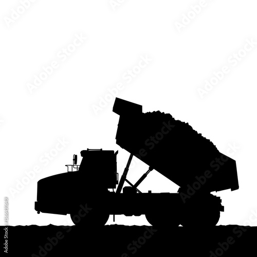 Silhouette of a heavy-duty dump truck unloading its cargo of rocks.