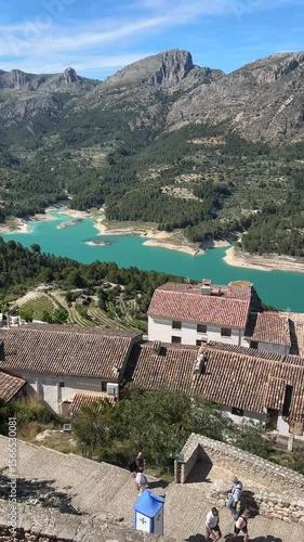 Aerial-Style View of Turquoise River and Spanish Village Rooftops