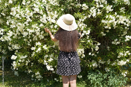 Enjoying a sunny day surrounded by blooming flowers in a picturesque garden while embracing the beauty of nature and the joy of outdoor exploration