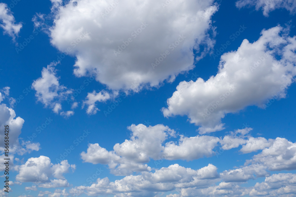 Fototapeta premium Sky and clouds. White cumulus clouds against blue sky with color gradient. Cloudy weather.