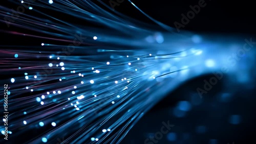 Fiber optic light beams flowing in motion on a dark blue background, representing digital connectivity and high speed data transfer in a tech network
