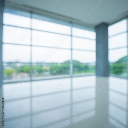 Empty modern office interior with large windows and natural light