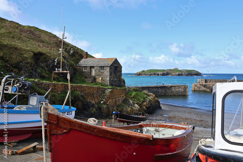 Quadro em tela Fishing boats at Mullion Cove Harbour, Cornwall; old stone building and historic
