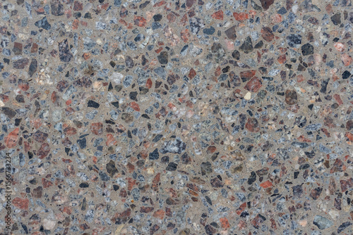 This abstract background showcases a textured surface composed of various materials, featuring a blend of colors and patterns. The neutral tones allow for effective copy space.